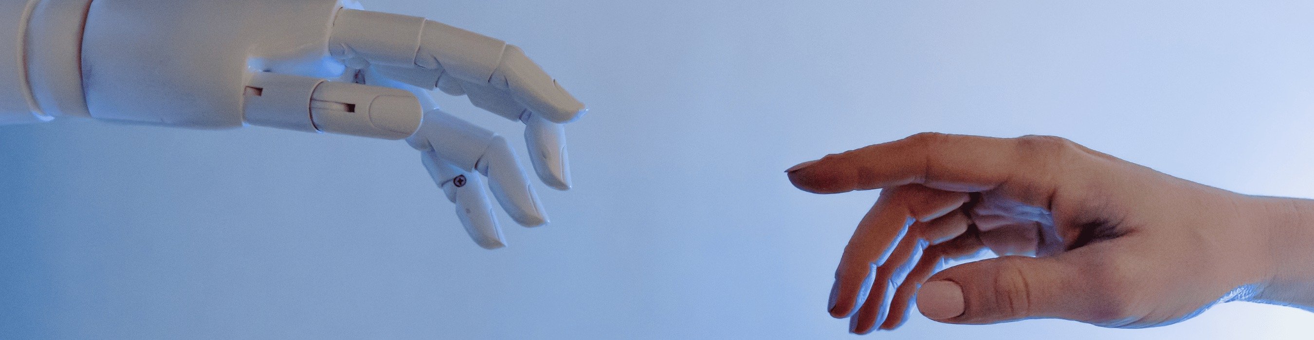 robot hand representing AI reaching out ot a human hand